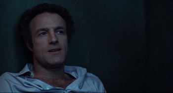 Movie still from “Thief” (1981), directed by Michael Mann – A person wearing a hooded shirt; Close Up shot, Low angle