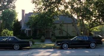 Movie still from “Thief” (1981), directed by Michael Mann – Two cars parked in front of a large house; Extreme Wide shot, Low angle