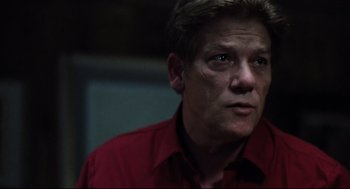 Movie still from “Thief” (1981), directed by Michael Mann – A person wearing a red shirt; Close Up shot, Low angle