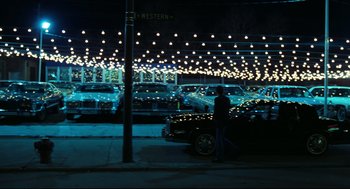 Movie still from “Thief” (1981), directed by Michael Mann – A man standing on the side of the road next to a parked car; Extreme Wide shot, High angle