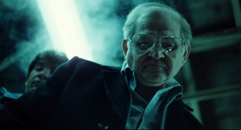 Movie still from “Thief” (1981), directed by Michael Mann – An old man with glasses is looking at the camera; Close Up shot, Low angle