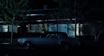 Movie still from “Thief” (1981), directed by Michael Mann – A car parked in front of a house at night; Wide shot, Low angle