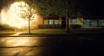 Movie still from “Thief” (1981), directed by Michael Mann – A building with a tree in front of it at night time; Extreme Wide shot, Low angle