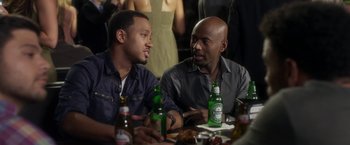 Movie still from “Think Like a Man” (2012), directed by Tim Story – A couple of men sitting at a table with drinks; Medium shot, Over the shoulder angle