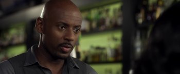 Movie still from “Think Like a Man” (2012), directed by Tim Story – A person wearing a gray shirt; Close Up shot, Over the shoulder angle