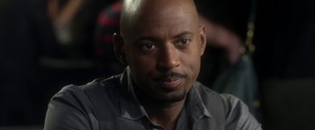 Movie still from “Think Like a Man” (2012), directed by Tim Story – A man with a shaved head and a black shirt; Close Up shot, Over the shoulder angle