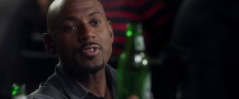 Movie still from “Think Like a Man” (2012), directed by Tim Story – A person holding a bottle of beer; Close Up shot, Over the shoulder angle