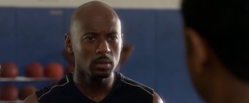 Movie still from “Think Like a Man” (2012), directed by Tim Story – A man with a bald head is looking at the camera; Close Up shot, Over the shoulder angle