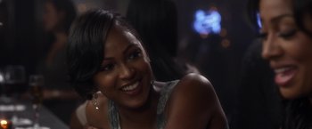 Movie still from “Think Like a Man” (2012), directed by Tim Story – A woman smiling for the camera in front of a crowd; Close Up shot, Over the shoulder angle