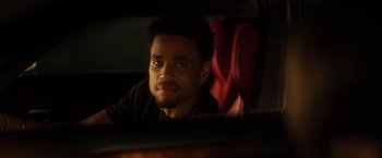 Movie still from “Think Like a Man” (2012), directed by Tim Story – A man sitting in the back seat of a car looking out the window; Close Up shot, Over the shoulder angle