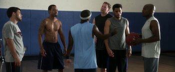 Movie still from “Think Like a Man” (2012), directed by Tim Story – A group of men standing in a gym; Medium shot, Over the shoulder angle