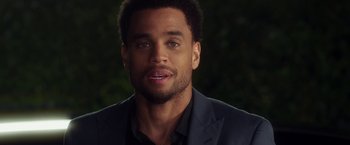 Movie still from “Think Like a Man” (2012), directed by Tim Story – A person wearing a suit and tie; Close Up shot, Over the shoulder angle