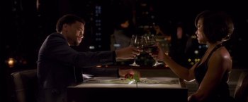 Movie still from “Think Like a Man” (2012), directed by Tim Story – A man and a woman are toasting with wine glasses; Medium shot, Overhead angle