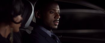 Movie still from “Think Like a Man” (2012), directed by Tim Story – A man wearing a suit and tie sitting in a car; Close Up shot, Over the shoulder angle