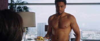 Movie still from “Think Like a Man” (2012), directed by Tim Story – A shirtless man standing in front of a plate of food; Medium shot, Overhead angle