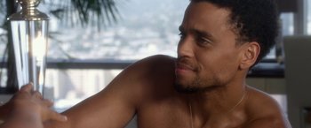 Movie still from “Think Like a Man” (2012), directed by Tim Story – A person with headphones on; Close Up shot, Over the shoulder angle