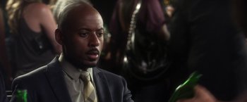 Movie still from “Think Like a Man” (2012), directed by Tim Story – A man wearing a suit and tie in front of a horse; Close Up shot, Over the shoulder angle