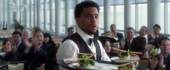 Movie still from “Think Like a Man” (2012), directed by Tim Story – A man holding a tray with food on top of it; Close Up shot, Over the shoulder angle