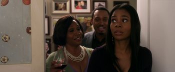 Movie still from “Think Like a Man” (2012), directed by Tim Story – A group of people that are standing in a room together; Close Up shot, Over the shoulder angle