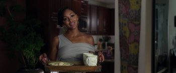 Movie still from “Think Like a Man” (2012), directed by Tim Story – A woman holding a tray of cookies and a mug; Medium shot, Over the shoulder angle