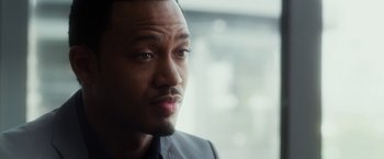 Movie still from “Think Like a Man” (2012), directed by Tim Story – A person wearing a suit and tie; Close Up shot, Over the shoulder angle