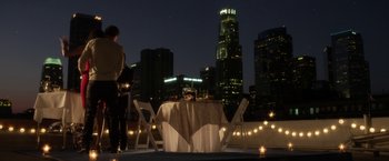 Movie still from “Think Like a Man” (2012), directed by Tim Story – A man standing next to a table on a rooftop; Extreme Wide shot, High angle