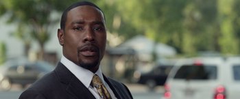 Movie still from “Think Like a Man” (2012), directed by Tim Story – A person wearing a suit and tie; Close Up shot, Over the shoulder angle
