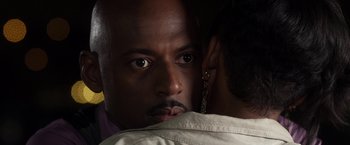 Movie still from “Think Like a Man” (2012), directed by Tim Story – A person with his face on a persons shoulder; Extreme Close Up shot, Over the shoulder angle