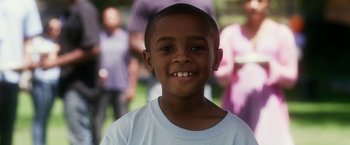 Movie still from “Think Like a Man” (2012), directed by Tim Story – A young boy smiling for the camera; Close Up shot, High angle