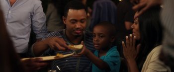 Movie still from “Think Like a Man” (2012), directed by Tim Story – A man and a boy are eating food together; Close Up shot, Over the shoulder angle