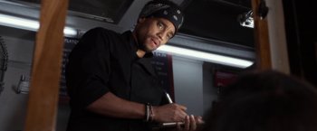 Movie still from “Think Like a Man” (2012), directed by Tim Story – A man in a black shirt and a black hat; Close Up shot, Over the shoulder angle