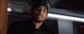 Movie still from “Think Like a Man” (2012), directed by Tim Story – A person wearing a black shirt; Close Up shot, Over the shoulder angle