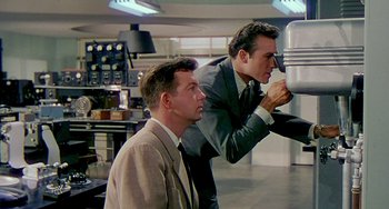 Movie still from “This Island Earth” (1955), directed by Joseph M. Newman – Two men in suits and ties in a room; Medium shot, Low angle