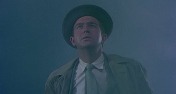 Movie still from “This Island Earth” (1955), directed by Joseph M. Newman – A man wearing a hat and a tie looking up; Close Up shot, Low angle