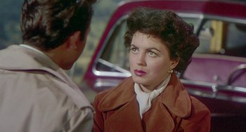 Movie still from “This Island Earth” (1955), directed by Joseph M. Newman – A woman in a brown jacket is talking to another woman; Close Up shot, Over the shoulder angle