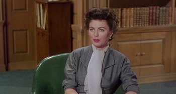 Movie still from “This Island Earth” (1955), directed by Joseph M. Newman – An older woman sitting in a chair wearing a jacket; Medium shot, Over the shoulder angle