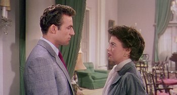 Movie still from “This Island Earth” (1955), directed by Joseph M. Newman – A man and a woman standing next to each other in a room; Medium shot, Over the shoulder angle