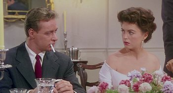 Movie still from “This Island Earth” (1955), directed by Joseph M. Newman – A man and a woman sitting at a dinner table; Close Up shot, Over the shoulder angle