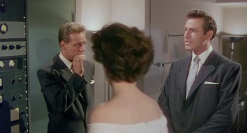 Movie still from “This Island Earth” (1955), directed by Joseph M. Newman – A man and a woman standing next to each other; Medium shot, Over the shoulder angle