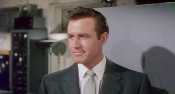 Movie still from “This Island Earth” (1955), directed by Joseph M. Newman – A person wearing a suit and tie; Close Up shot, Low angle