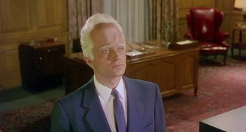 Movie still from “This Island Earth” (1955), directed by Joseph M. Newman – A man in a suit and a tie; Close Up shot, High angle