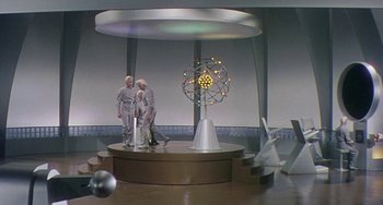 Movie still from “This Island Earth” (1955), directed by Joseph M. Newman – Two men standing in front of a large sculpture; Extreme Wide shot, High angle