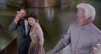 Movie still from “This Island Earth” (1955), directed by Joseph M. Newman – A man and a woman standing next to each other; Medium shot, Over the shoulder angle