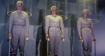 Movie still from “This Island Earth” (1955), directed by Joseph M. Newman – A group of men in purple suits and white hats; Wide shot, Low angle