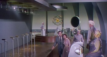 Movie still from “This Island Earth” (1955), directed by Joseph M. Newman – A man and a woman standing in front of a mirror in a room; Extreme Wide shot, High angle