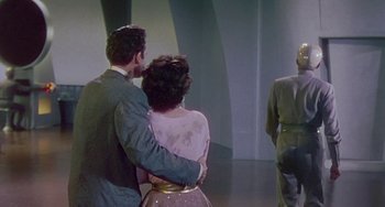 Movie still from “This Island Earth” (1955), directed by Joseph M. Newman – A man and a woman are hugging in front of a wall; Medium shot, Low angle