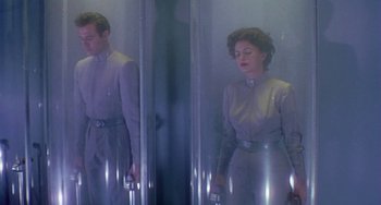 Movie still from “This Island Earth” (1955), directed by Joseph M. Newman – A man and a woman standing next to each other; Wide shot, Low angle