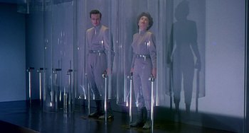 Movie still from “This Island Earth” (1955), directed by Joseph M. Newman – A man and a woman standing next to each other; Wide shot, Low angle