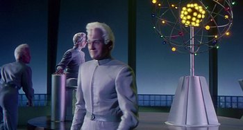 Movie still from “This Island Earth” (1955), directed by Joseph M. Newman – A man standing in front of another man in a suit; Medium shot, Low angle