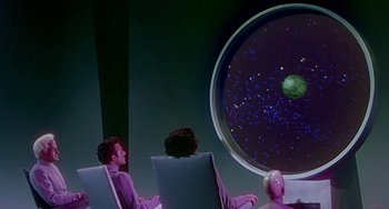 Movie still from “This Island Earth” (1955), directed by Joseph M. Newman – A group of people sitting in front of a large window; Extreme Wide shot, High angle